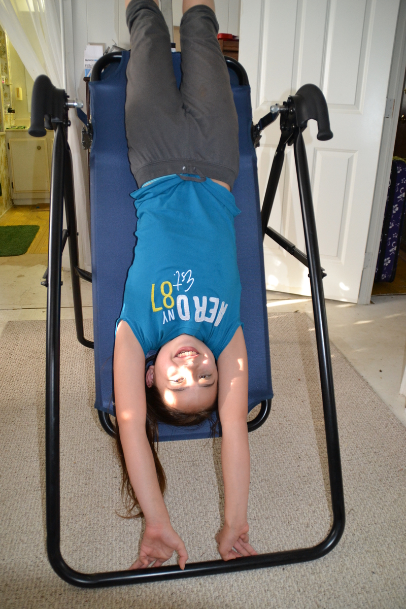 The first thing that Latia wants to do is go on Grandma and Grandpa's inversion table.