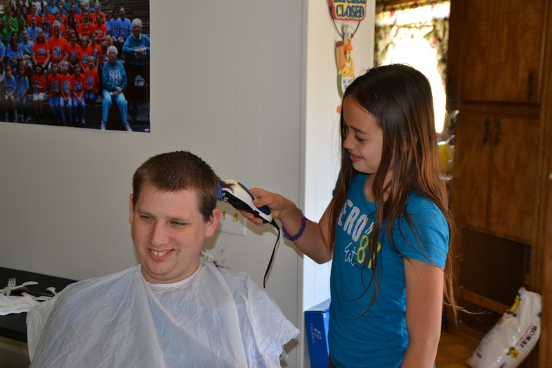 Isaac getting his hair cut by Latia.