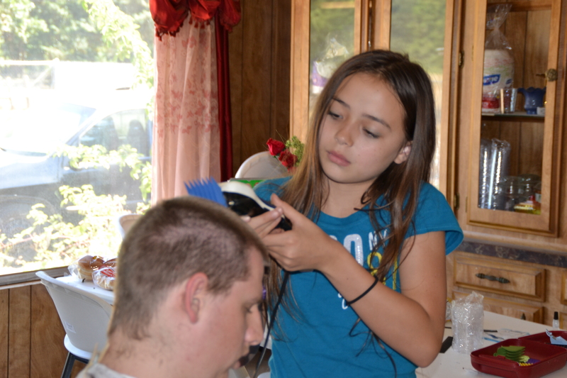 Latia cutting Isaac's hair.
