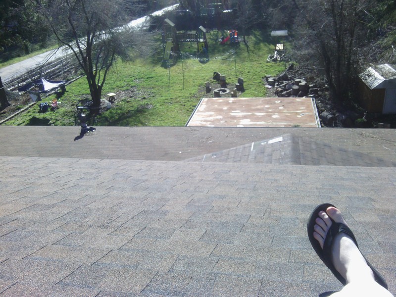 View south from the top of the highest roof. Cricket is visible. South roof is visible. Pop-out is visible. Play structure is visible.