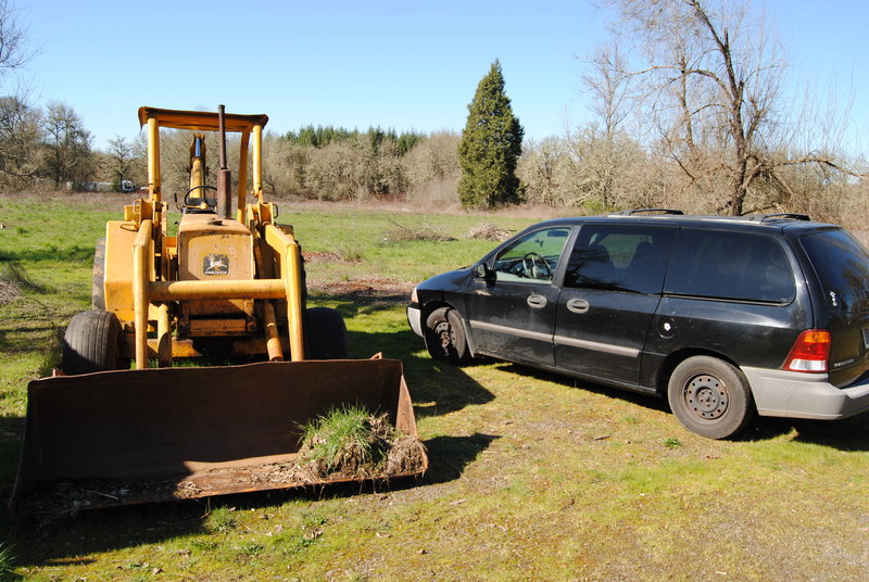 Trying to jump start Goliath the backhoe with the van.
