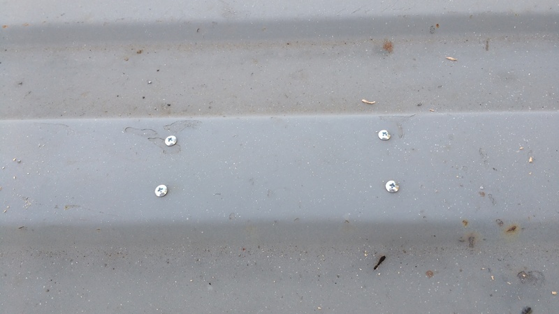 Here we see the screws from the top of the container down into the block of wood.