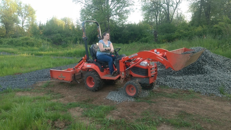 Stacia operates Goldie to lay down some gravel.