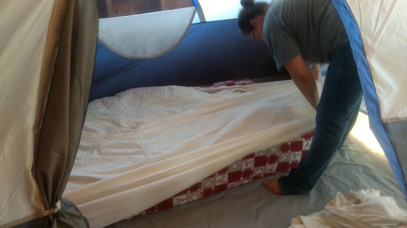 Tent in the unfinished Americana Room. Stacia is arranging bedding.