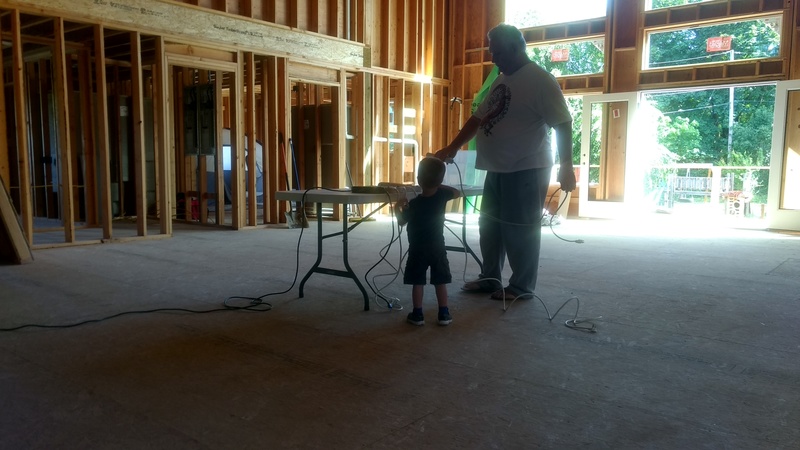 Austin and Grandpa Don look at the charging station in the Great Room.