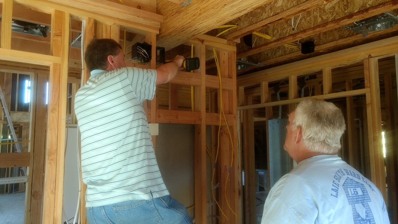Joseph and Don drill holes and install network wiring (Cat6).