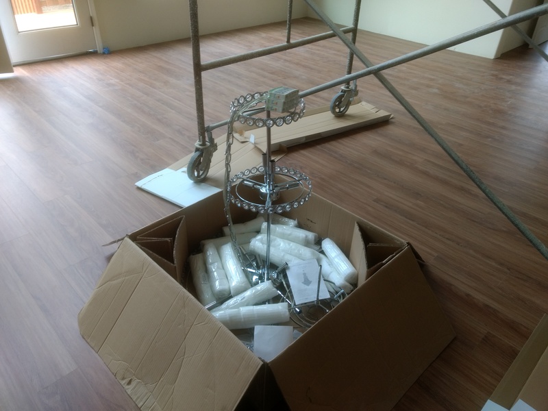 Chandelier, still in the box but partly assembled.