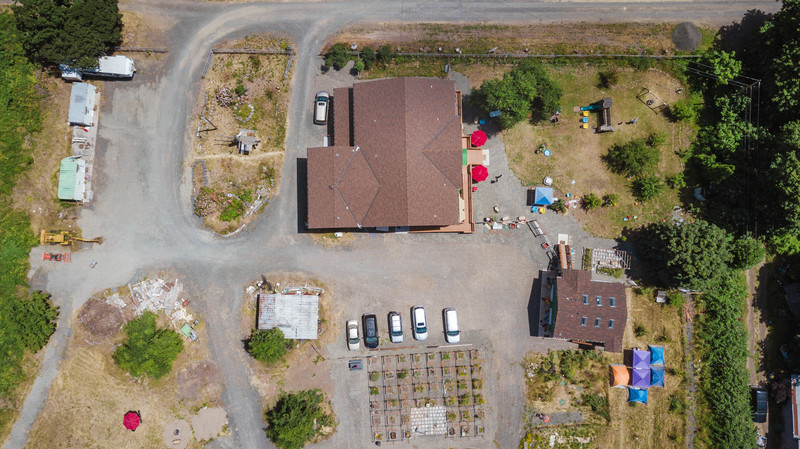 Drone picture by Jade Sundstrom of Rosewold's Great House (center top), Picnic Area (right top), Guest House (center right), Tent City (lower right), Waffle (center bottom), West Parking Lot (center center), North Parking Lot (left top), and Fire Pit (left bottom).