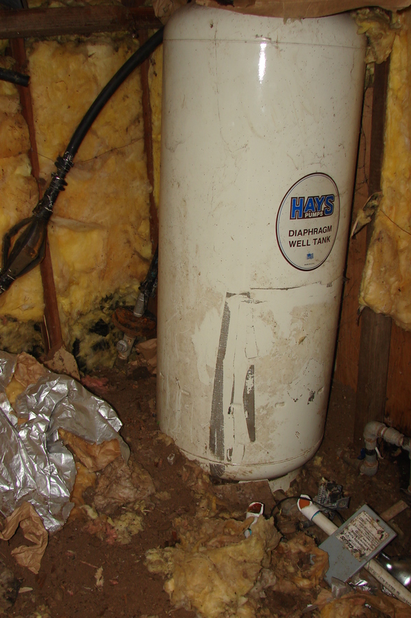 Well house - inside.  Notice the fiberglass falling down. "Hays Pumps, Diaphragm Well Tank"