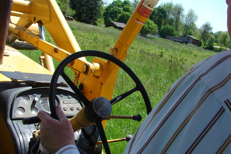 The steering wheel and backhoe dashboard.