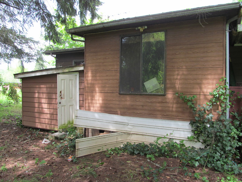 West of Porch: the South Wing. Beyond is SW Storage Room (external)
