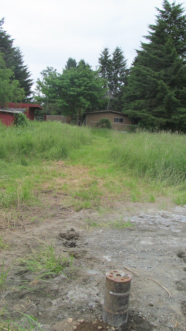 Well, looking East towards the cottage. The well is just slightly north of the middle of the cottage. Carport.