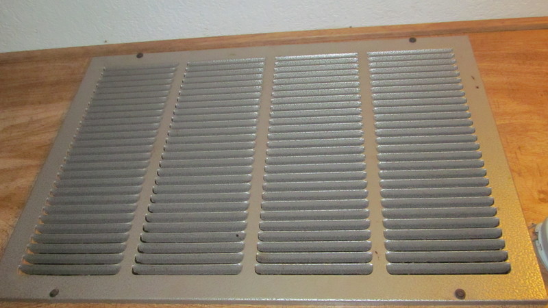 Heating/cooling vent above washer and dryer.