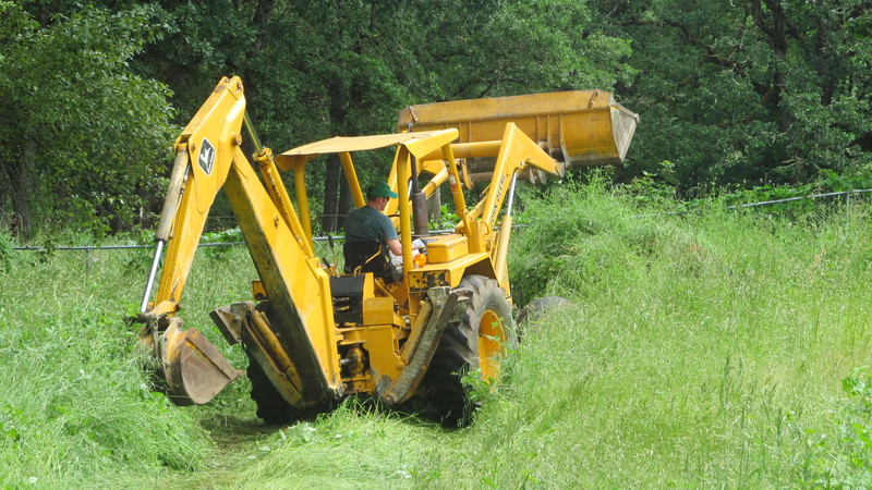 Then after a while Goliath the backhoe lost power. We think it needs a new air filter, but we're not sure where it is.