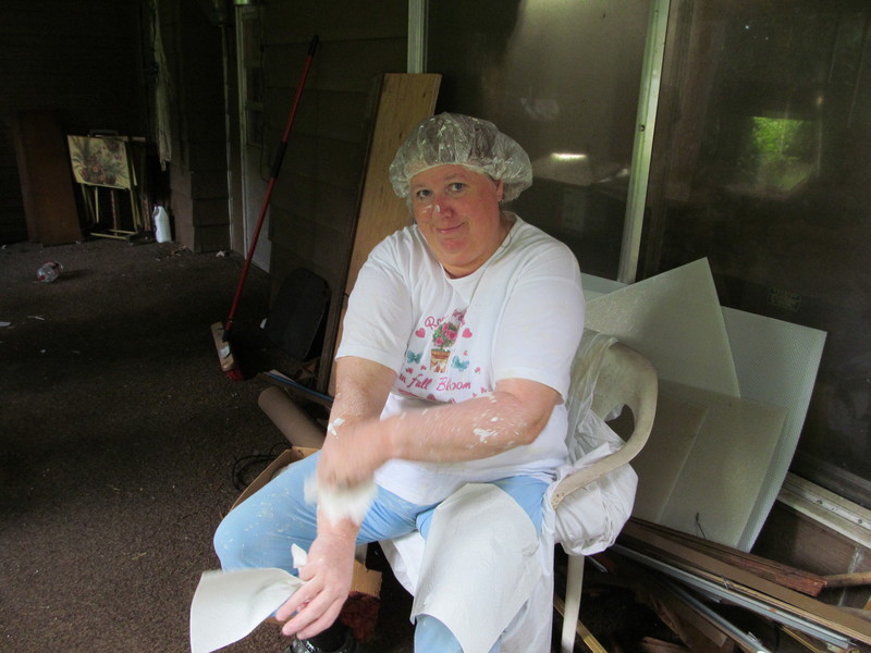 Master Painter, removing excess paint. Stylish hair net.