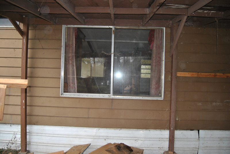 China room window from outside. Future front door. Carport.