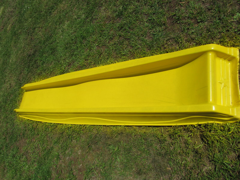 The yellow slide after I sprayed a can of yellow paint on one side. Play structure progress.