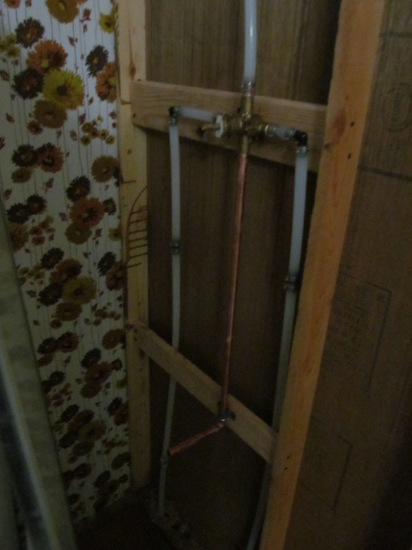 Bottom half of the shower plumbing. Shower progress. Pex probably.