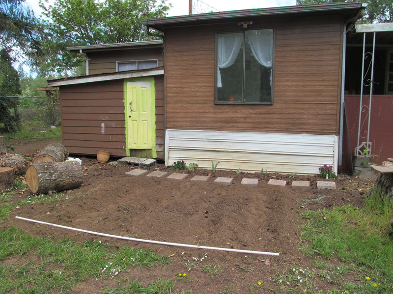 The Clubhouse garden begins. Joseph rototilled it and made the rows.