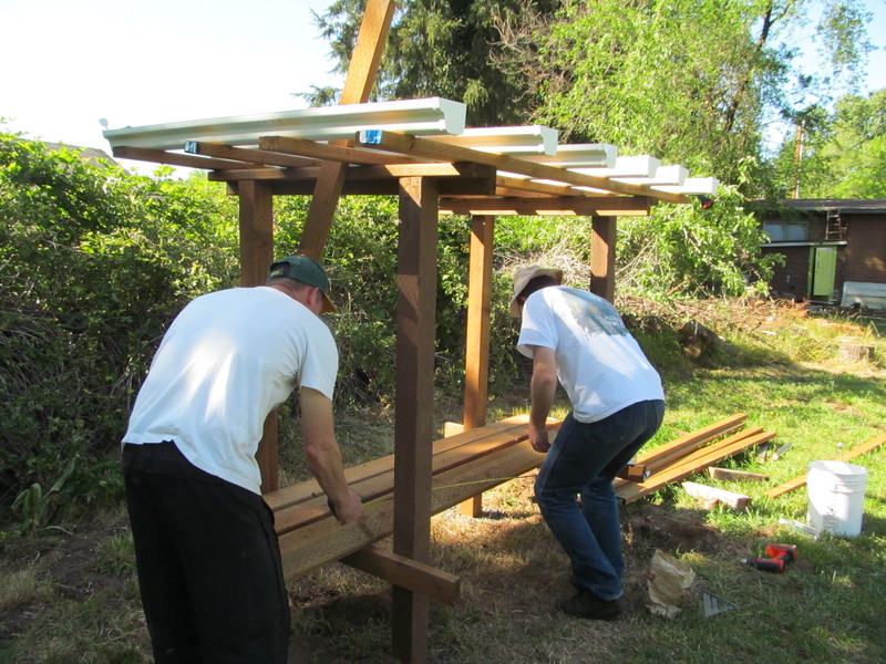 Chuck and Joseph are working on the strawberry bench.
