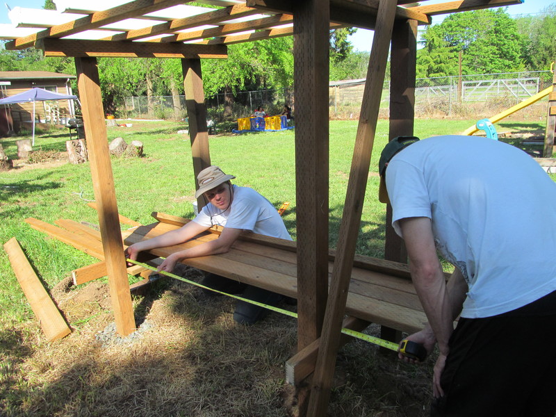 Chuck and Joseph are working on the strawberry bench.