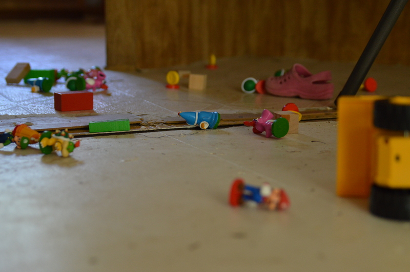 Toys attempt to escape through a narrow crack in the floor.