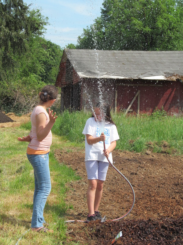 Abby watering Shannon. Will this help her grow? Farm.