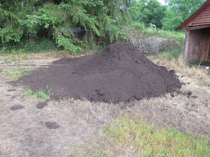 The dirt/compost pile is getting smaller as it's moved to the garden.