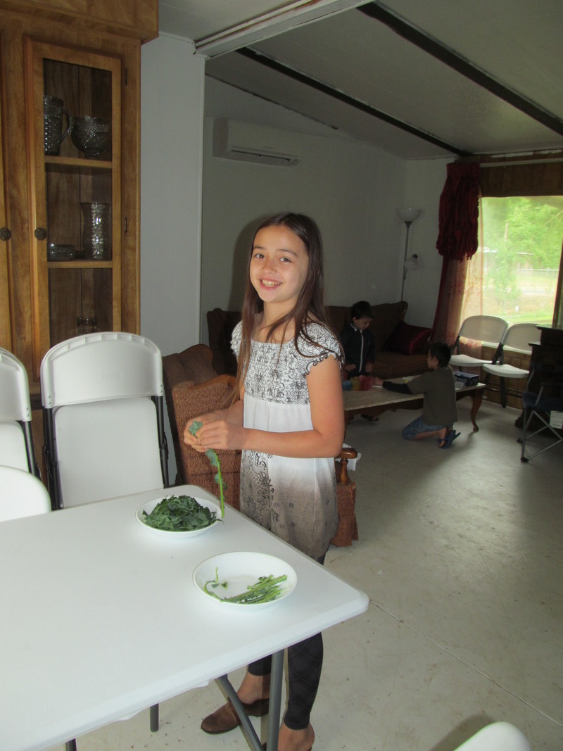 Latia prepares kale.
