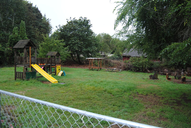 Nice view of the Picnic area, Play Structure, and Arbor from the East Fence.