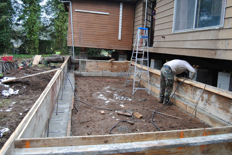Nailing up the boards to prepare for more concrete.