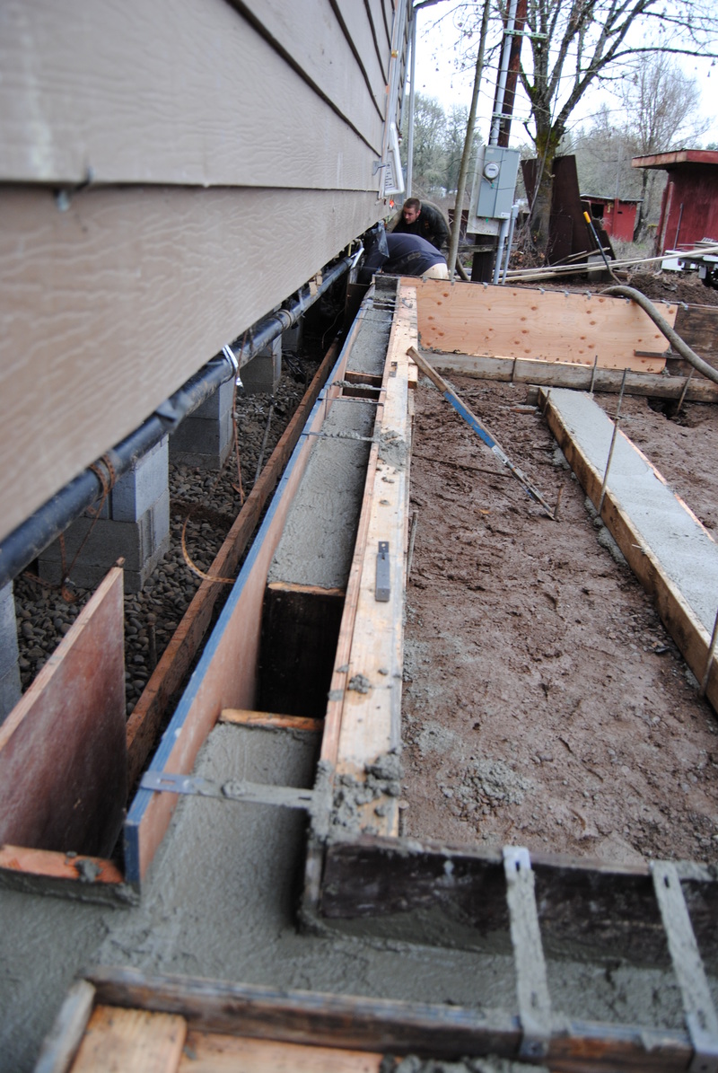 Showing holes in the foundation for crawl spaces.