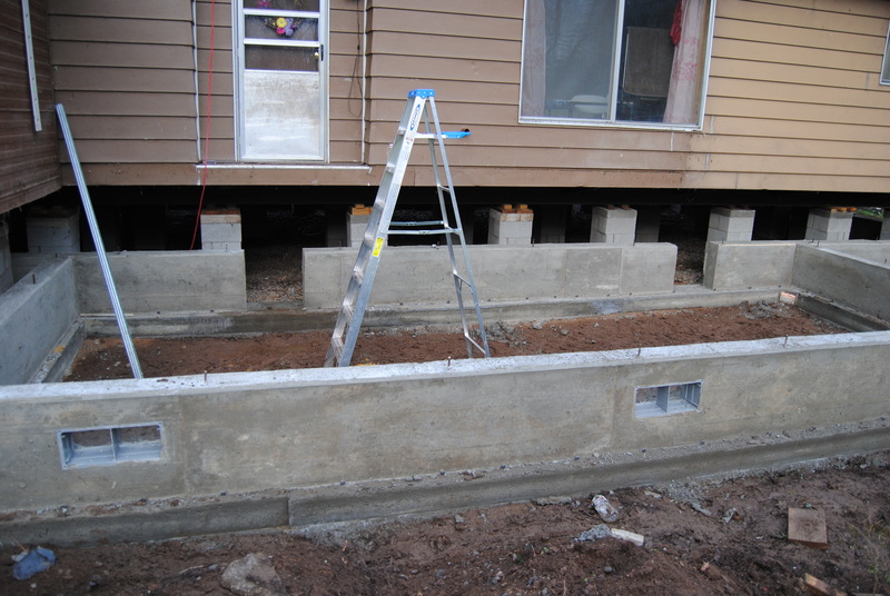 Back porch area, foundation and stem walls, ladder to back door.