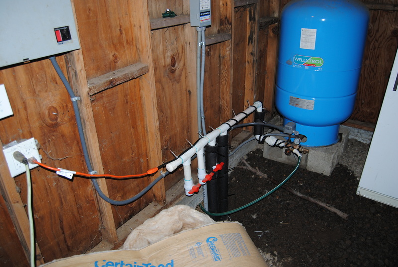 Rewrapping of heater tape on the main water supply system. The heat tape also goes inside the insulation noodles.