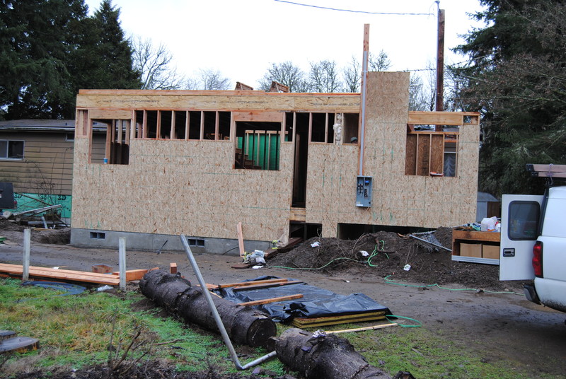 Picture of the front side of the house.  Shows the power box being installed.