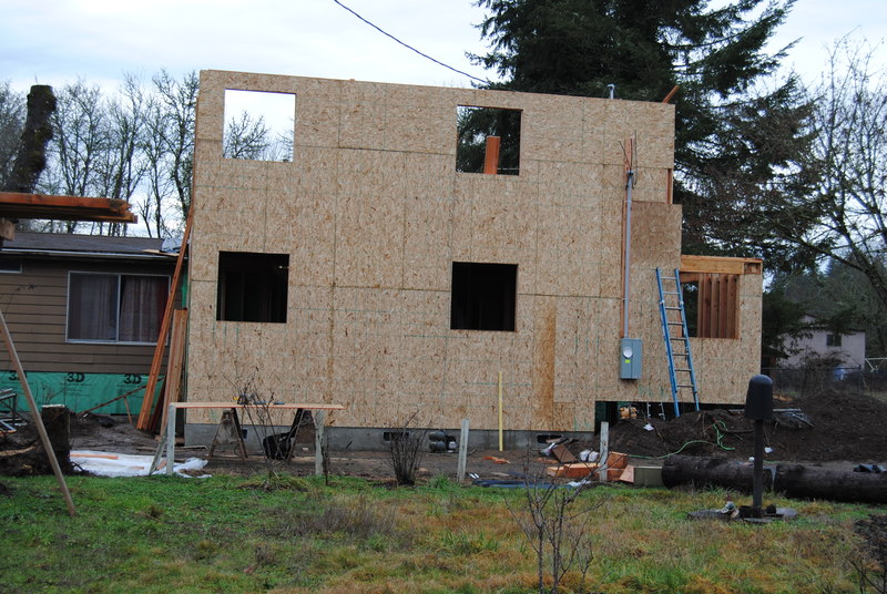 View of north wall of addition, showing Don's study below and Lois's loft above, and electric meter box.