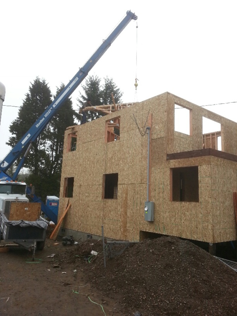 Lifting a bundle of trusses into place.