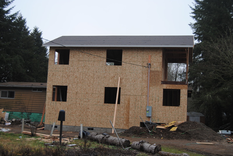 View of the north face of the addition. Roofing felt can be seen. Power connection (weather head, meter box) can be seen.