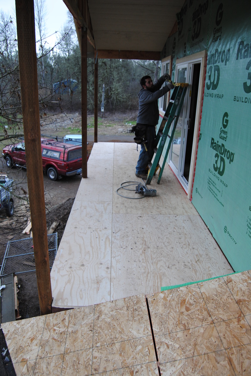 View from the west end of the cricket, across the balcony, showing the installation of the sliding glass door. The balcony deck itself is in place and looking very sturdy.
