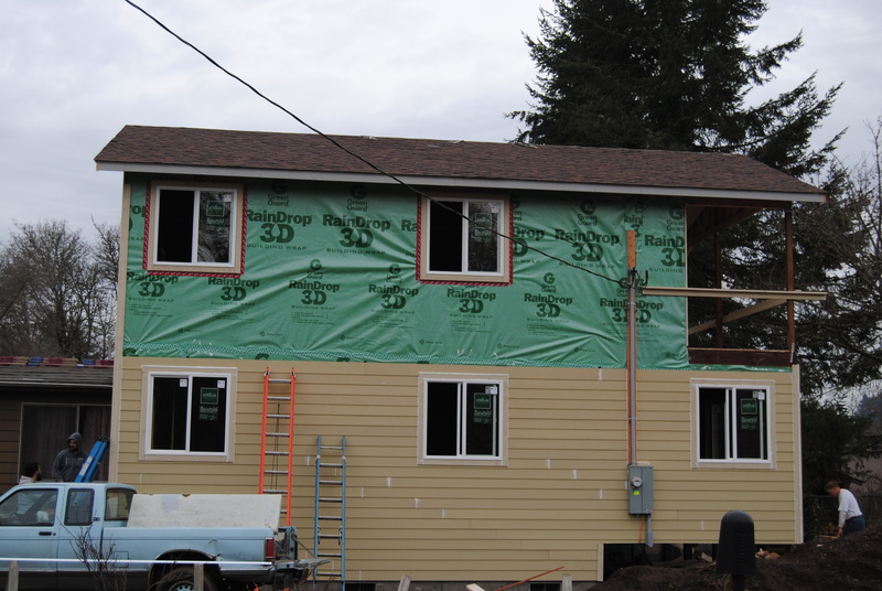 View of the north face of the addition. Siding goes about half way up the structure.