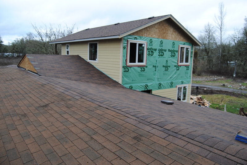 View of the north half of the old house roof. Shingles match nicely. View of the south wall of the addition. Siding is in place. View of the east wall of the addition. Siding is halfway done.