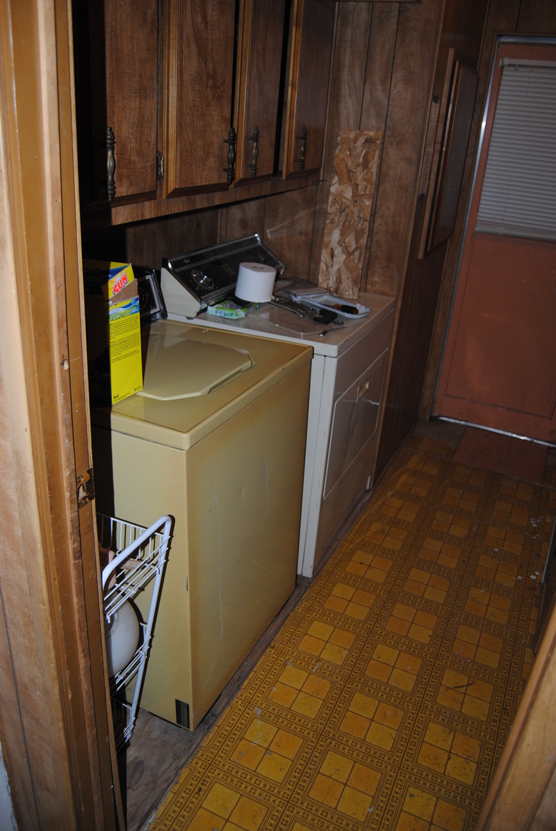 Washer is back in place. Mushy floor replacement is also seen at the end of the hallway.