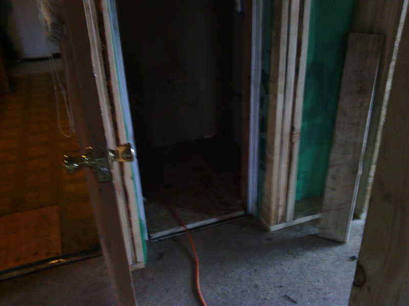 View from the addition hallway back through the utility door, and also into the furnace and water heater space.