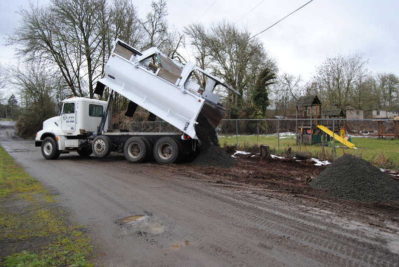Gravel being dumped along the west side of Rosewold Lane.