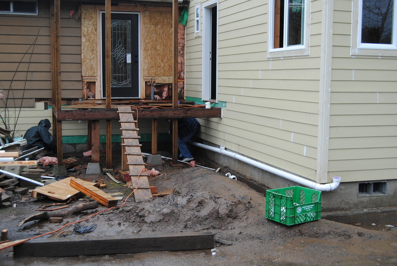 Rain pipes being installed under the front porch.
