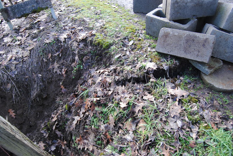 Culvert sinkhole, crack line showing where the ground subsided.