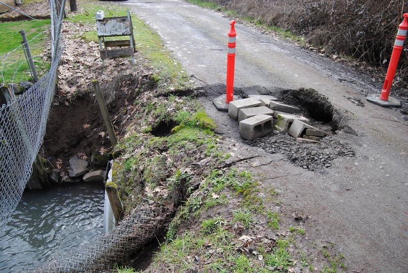 Culvert sinkhole. Someone has recently driven over the edge, enlarging the hole. Compare with photos from last Thursday.