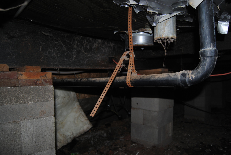 Plumbing under the north half of the old house. Vents appear to be for the clothes dryer.
