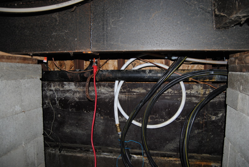 Wires and hoses under the utility room.