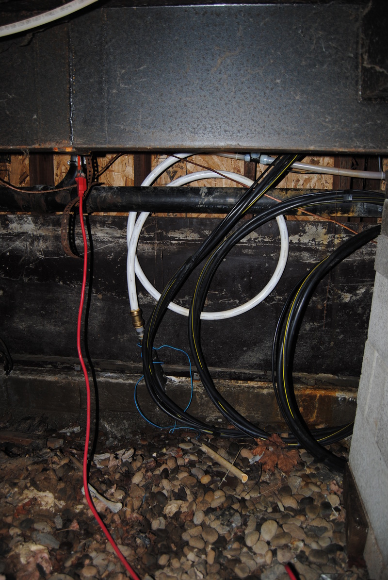 Wires and hoses under the utility room.